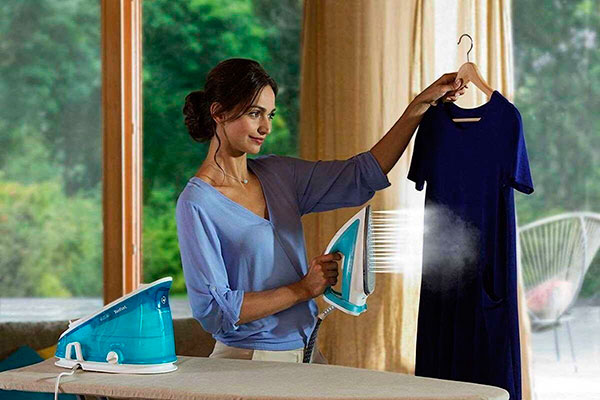 Девушка отпаривает одежду